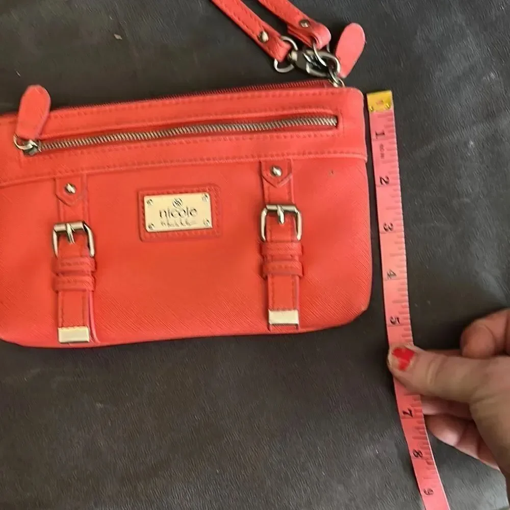 Nicole by Nicole Miller salmon colored Wristlet with Gold Details